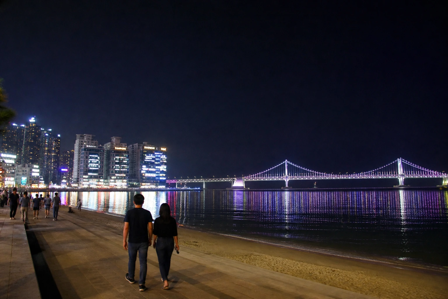 부산 광안리해수욕장 밤바다와 광안대교 야경을 담은 장면으로, 차 없이 걷는 부산 뚜벅이 여행의 마무리 분위기를 보여주는 이미지
